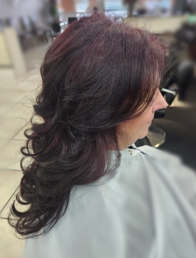 Dark layered curls viewed from the side